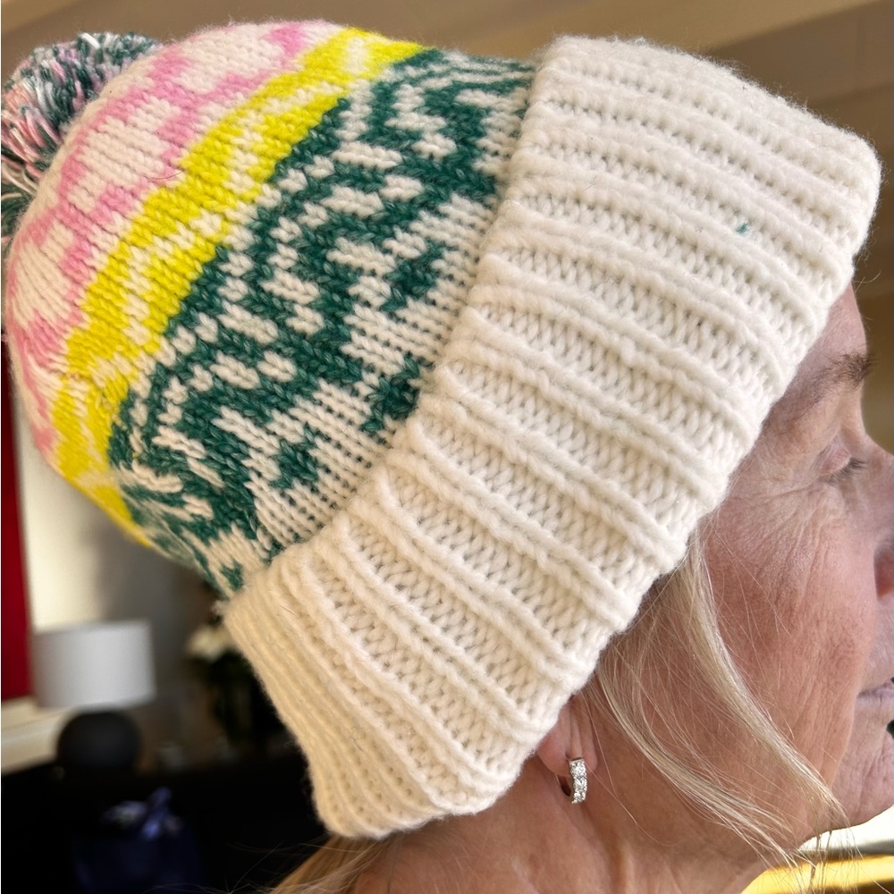 Cute knit hat in cream, pink, yellow and green.